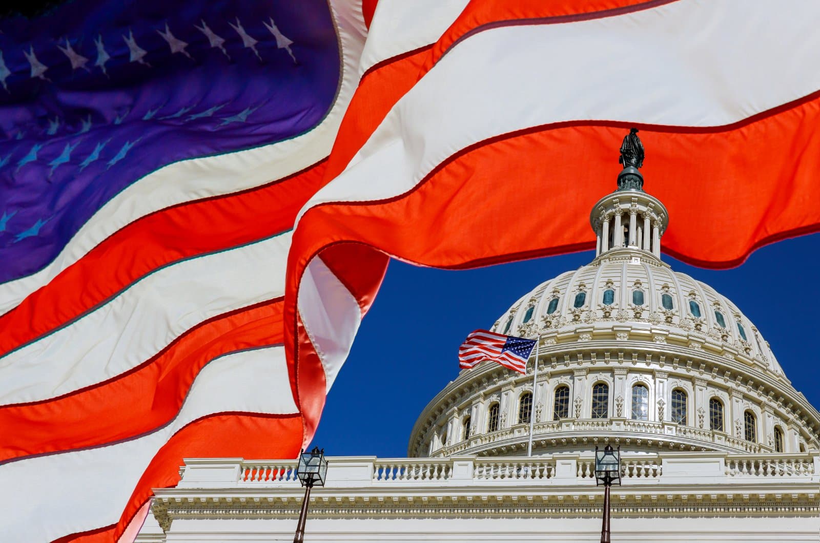 United States Capitol building with American flag, where Congress is weighing the Take Care of America's Veterans Act